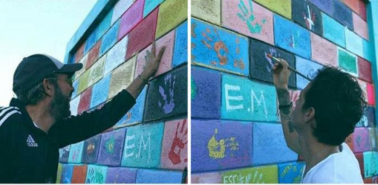 Gesto. Los cantantes Juan Luis Guerra y Marc Anthony dejaron sus huellas en el colorido mural exterior pintado por los chicos del orfanato. Niños de Cristo
