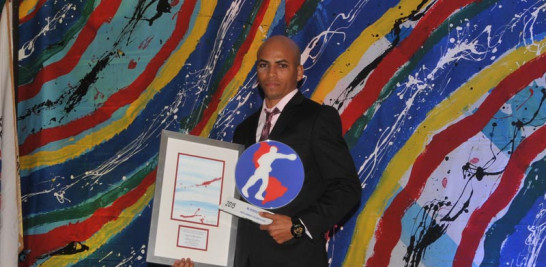 Héctor Luis García exhibe su placa y una pintura que le fue otorgada tras su elección como Boxeador del Año.