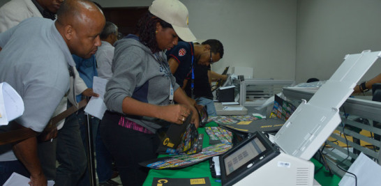 Miembros de los colegios electorales revisaban ayer los votos nulos y contaban con los equipos electrónicos las boletas de votación en la sede de la Junta Electoral del Distrito Nacional.