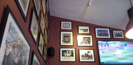 Equinos. Los caballos andaluces son el tema de las fotografías que decoran Gloria Bendita . Una televisión en lo alto transmite un partido de fútbol.
