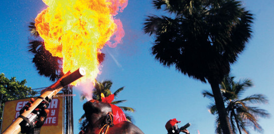 04/03/2012. Dos hombres lanzan fuego durante su participación en el Gran Desfile Nacional de Carnaval en Santo Domingo. EFE/Orlando Barría.