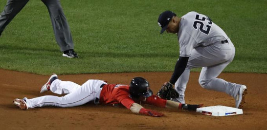 El segunda base de los Yankees de Nueva York, Gleyber Torres (derecha), trata de poner out en la intermedia a Andrew Benintendi, quien se estafó la intermedia.