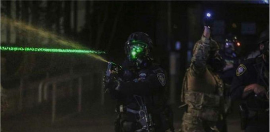 Policías son molestados con punteros laser durante protestas en Estados Unidos. / AP