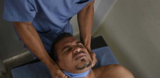 Un quiropráctico atiende a un paciente de COVID-19 en recuperación en un centro de salud. Foto: AP/Matías Delacroix.