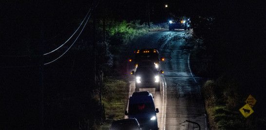 Un convoy de vehículos policiales sale de las casas del padre y el hermano de Robert Card en Bowdoin, a 24 kilómetros (15 millas) de Lewiston, Maine, el 26 de octubre de 2023, el día después de un tiroteo masivo.