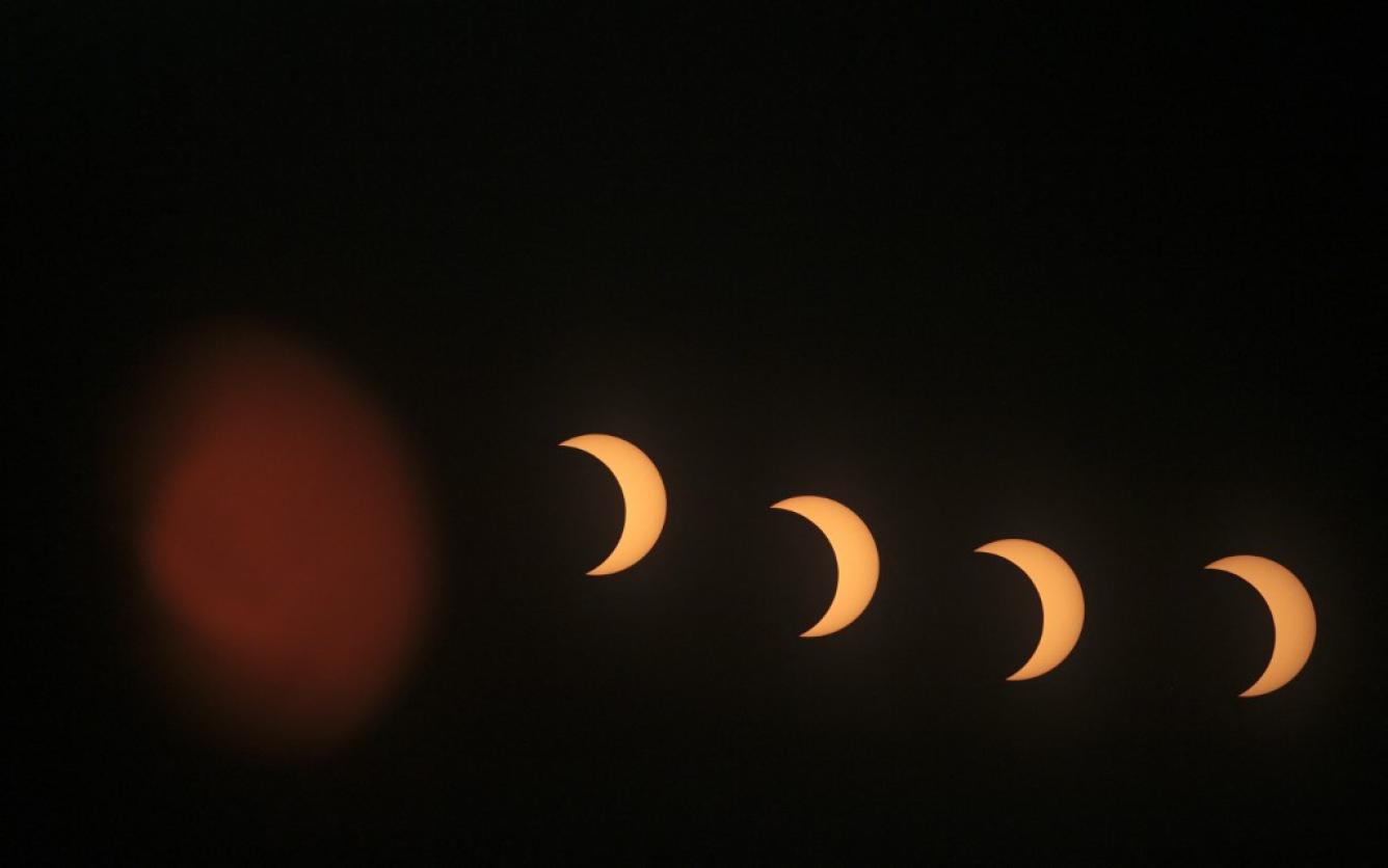 This multi-exposure image shows the annular solar eclipse as seen from the Pierre & Marie Curie School in Managua on October 14, 2023. OSWALDO RIVAS / AFP