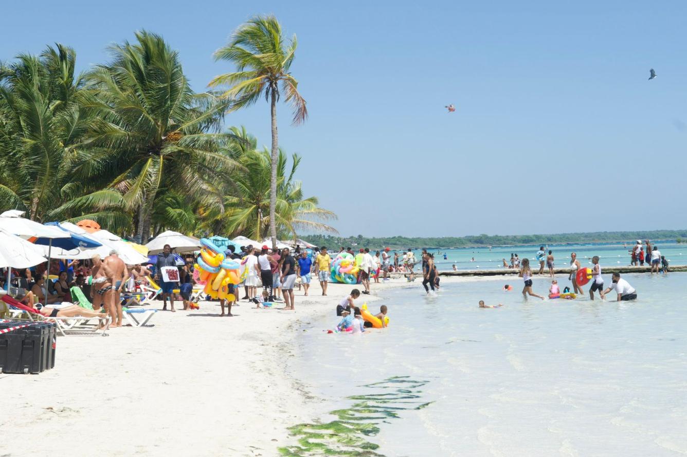 Niños y adultos se bañan en la Playa Boca Chica, en Santo Domingo.