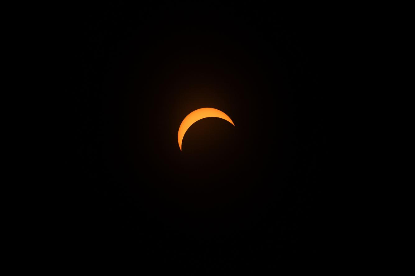 COLEBROOK, NEW HAMPSHIRE - APRIL 8: The moon crosses in front of the sun during the Great North American Eclipse on April 8, 2024 in Colebrook, New Hampshire. Millions of people have flocked to areas across North America that are in the 