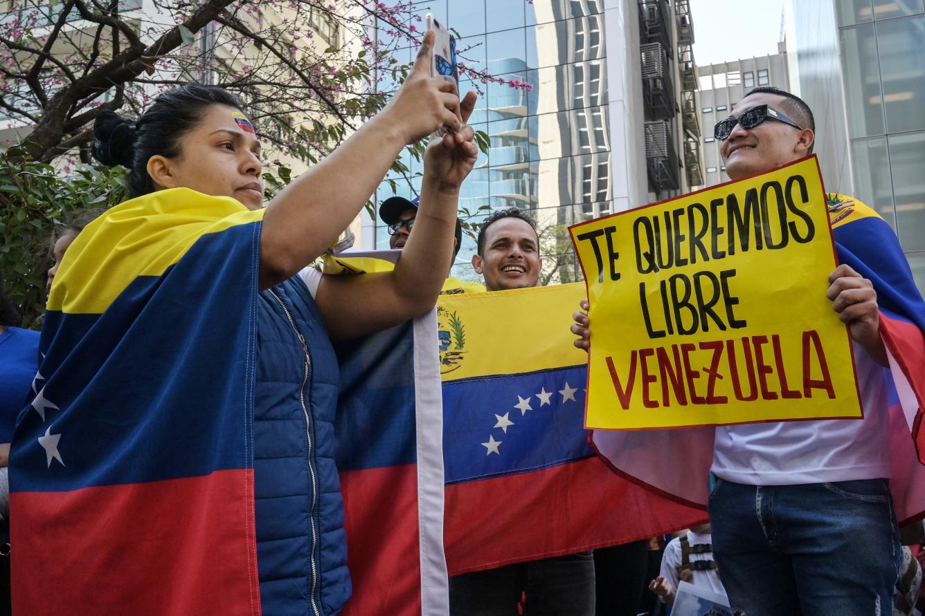 Venezuelan citizens take part in a protest in support of the Venezuelan opposition in Brasília, Brazil, on July 28, 2024. Venezuelans vote Sunday between continuity in President Nicolas Maduro or change in rival Edmundo Gonzalez Urrutia amid high tension following the incumbent's threat of a 