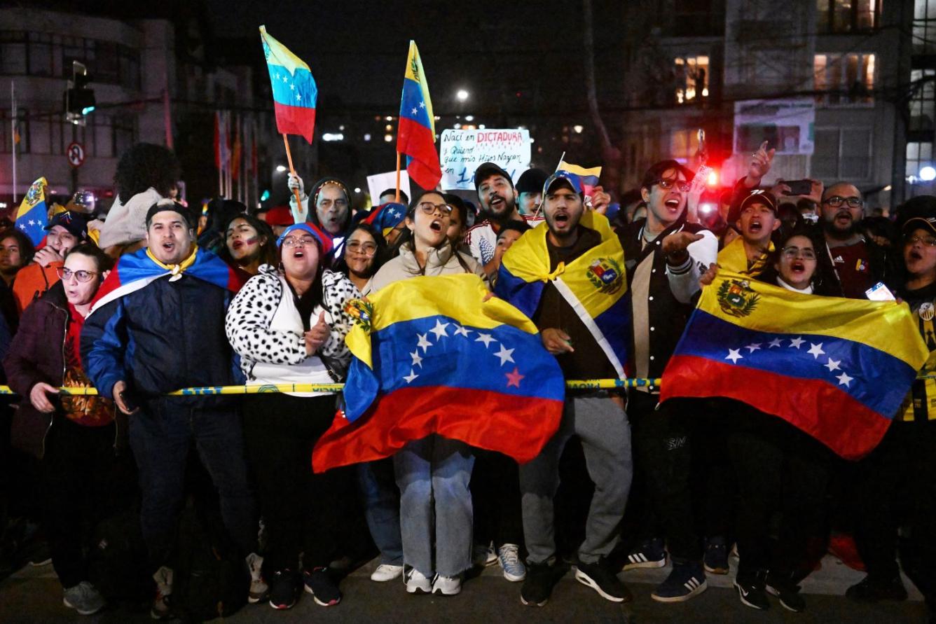 Los venezolanos que viven en Chile y los opositores del presidente venezolano Nicolás Maduro se reúnen frente al consulado de Venezuela en Santiago, Chile.
