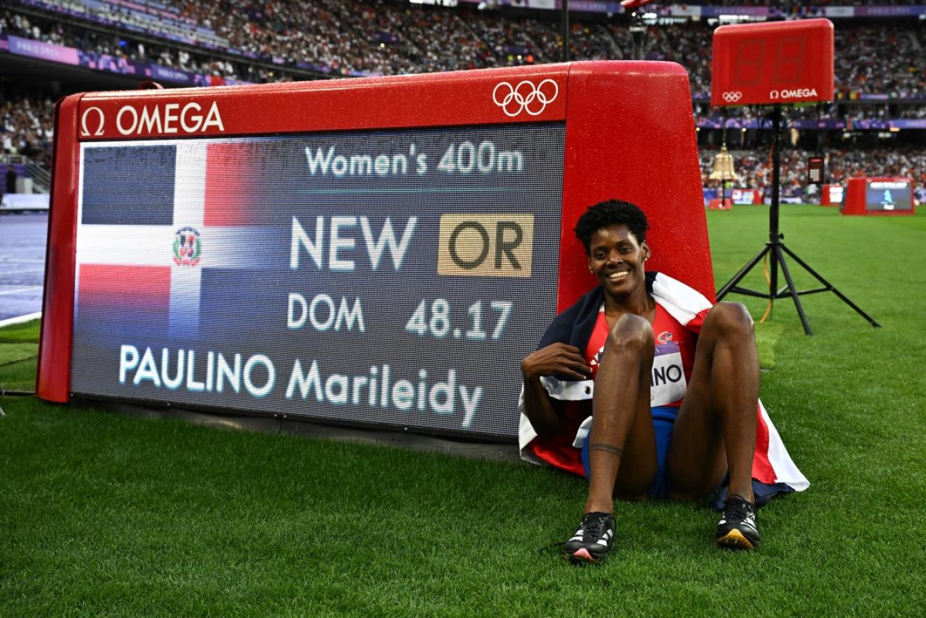 Dominican Republic's Marileidy Paulino celebrates winning the women's 400m final and setting the new Olympic record during athletics competitions at the Paris 2024 Olympic Games at Stade de France in Saint-Denis, north of Paris, on August 9, 2024. (Photo by Ben STANSALL / AFP)