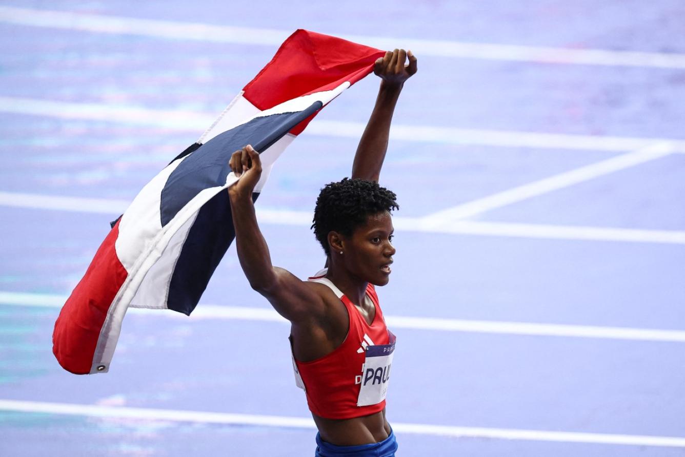 Dominican Republic's Marileidy Paulino celebrates after winning the women's 400m final of the athletics event at the Paris 2024 Olympic Games at Stade de France in Saint-Denis, north of Paris, on August 9, 2024. (Photo by Anne-Christine POUJOULAT / AFP)