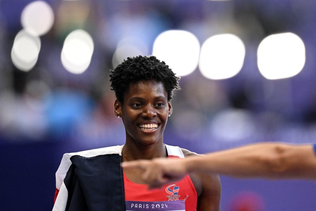 Dominican Republic's Marileidy Paulino celebrates after winning the women's 400m final of the athletics event at the Paris 2024 Olympic Games at Stade de France in Saint-Denis, north of Paris, on August 9, 2024. (Photo by Kirill KUDRYAVTSEV / AFP)