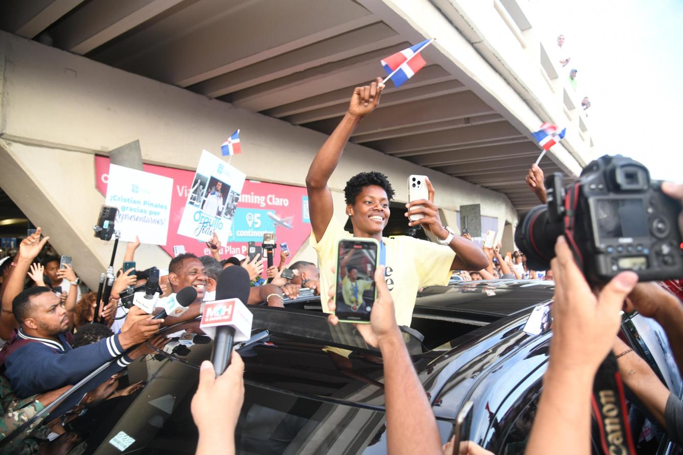 Camarógrafos rodean el vehículo donde iba Marileidy con la bandera en mano