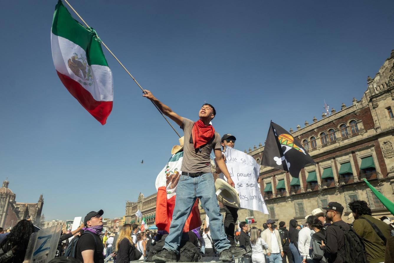 Demonstrators clash with riot police at a rally against the government of Mexico's President Claudia Sheinbaum at Zocalo Square in Mexico City on November 15, 2025. Thousands of people marched through the streets of Mexico City on Saturday to protest against drug violence and the security policies of President Claudia Sheinbaum's government. (Photo by Eva FONSECA / AFP)