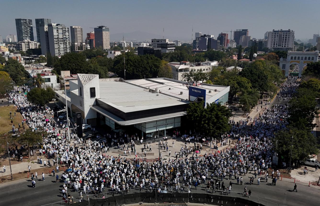 A man stands in front of Mexican riot police during a demonstration against the government of Mexico's President Claudia Sheinbaum at Zocalo Square in Mexico City on November 15, 2025.. (Photo by Alfredo ESTRELLA / AFP)