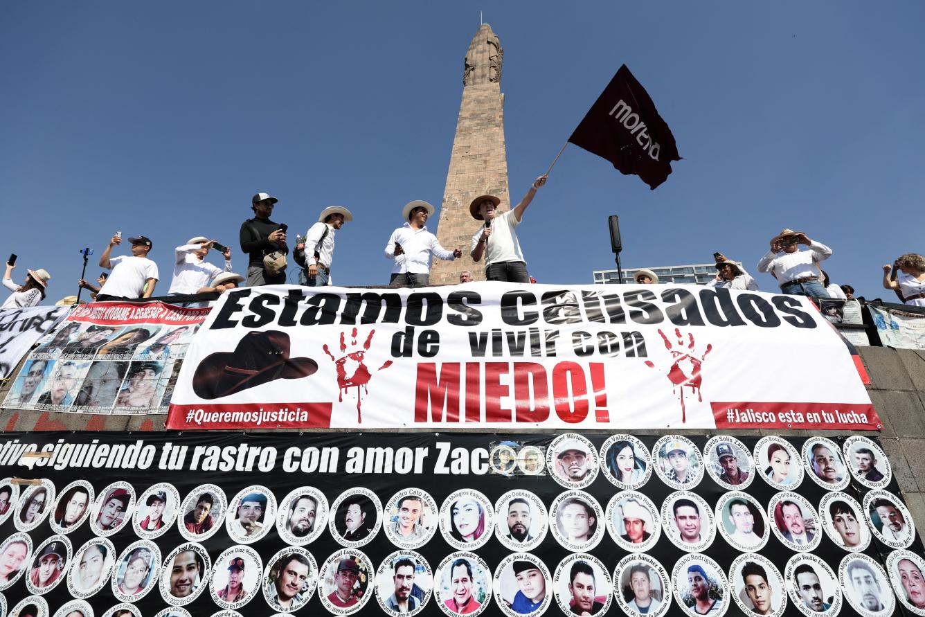 An injured demonstrator is helped by paramedics during clashes with riot police at a rally against the government of Mexico's President Claudia Sheinbaum at Zocalo Square in Mexico City on November 15, 2025. Thousands of people marched through the streets of Mexico City on Saturday to protest against drug violence and the security policies of President Claudia Sheinbaum's government. (Photo by Eva FONSECA / AFP)