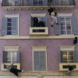 People are reflected in a giant mirror as they take part in the installation by Leandro Erlich at the Palazzo Reale, during the Design Fair exhibition, in Milan, Italy, Saturday, April 22, 2023. ((AP Photo/Luca Bruno)