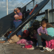 Migrantes hondureños esperan entrar a México sobre un puente fronterizo, en Tecún Umán, Guatemala, el domingo 21 de octubre de 2018.