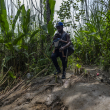 Un migrante que lleva a su bebé camina por la selva cerca de la aldea de Bajo Chiquito, el primer control fronterizo de la provincia de Darién en Panamá.