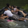 Migrantes cruzan el río Bravo en un colchón inflable hacia Estados Unidos