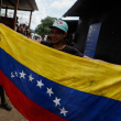 Un migrante venezolano sostiene la bandera venezolana durante su estadía en la Estación de Recepción de Migrantes en Lajas Blancas, provincia de Darién, Panamá, el 6 de octubre de 2023.