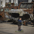 Un niño monta en patineta junto a una exposición de vehículos rusos destruidos en la plaza Mykhailivska del centro de Kiev, Ucrania, el martes 22 de octubre de 2024.