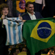 El presidente argentino Javier Milei sostiene una camiseta de la selección nacional de fútbol junto al aspirante presidencial de derecha de Brasil, Flavio Bolsonaro, quien sostiene una bandera nacional.