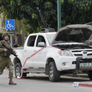 Un soldado israelí pasa junto a una camioneta utilizada por milicianos palestinos en Sderot, Israel, el sábado 7 de octubre de 2023.