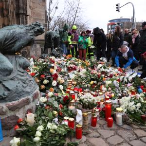 La gente deposita flores y velas en el lugar de un ataque con coche en un mercado navideño en Magdeburgo, este de Alemania, el 21 de diciembre de 2024, que provocó varias muertes y decenas de heridos.