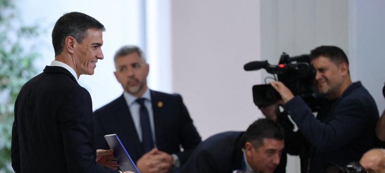 El presidente del Gobierno español, Pedro Sánchez, sostiene un folleto con los logros de su gobierno tras una rueda de prensa en el Palacio de la Moncloa, ayer en Madrid.