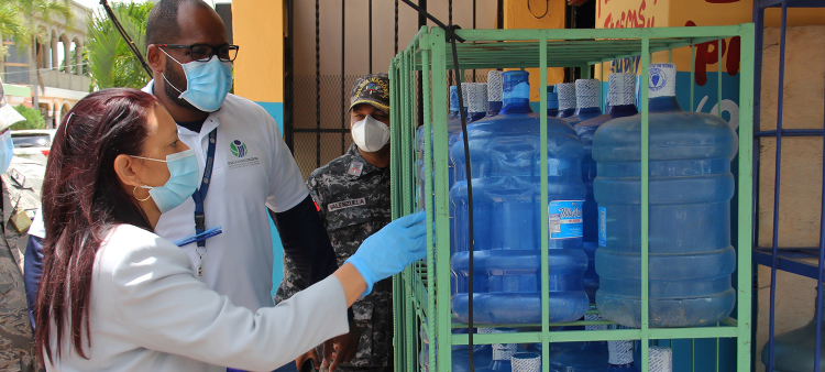 Inspectores de ProConsumidor durante un operativo de inspección al agua en botellones expuesta a la venta en anaqueles.