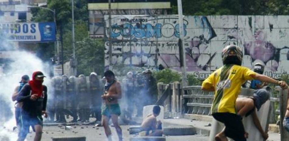 Personas que se dedican al transporte de mercancías entre Venezuela y Colombia, conocidas como 'Maleteros' chocan contra la policía venezolana durante una protesta en Cúcuta, Colombia, el 29 de julio de 2015 (AFP | Schneider Mendoza).