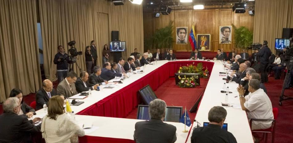 Archivo. El presidente venezolano, Nicolás Maduro, al fondo, se reúne con miembros de la Mesa de Unidad Nacional y representantes del nuncio eclesiástico venezolano y cancilleres de Unasur, el 10 de abril de 2014, en el Palacio de Miraflores, en Caracas.