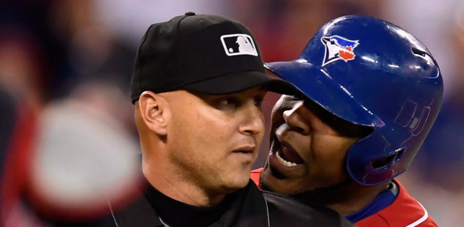 Edwin Encarnación, de los Azulejos, discute en el rostro del umpire Vic Carapazza antes de ser expulsado en el primer inning del partido ante los Indios de Cleveland en Toronto, el viernes.