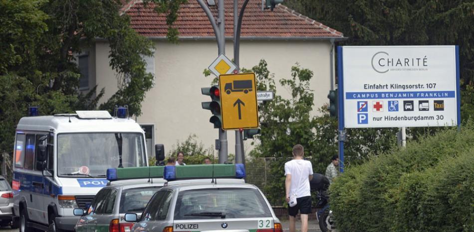 Varios coches de policía permanecen delante del hospital Benjamin Franklin en Berlín, Alemania hoy, 26 de julio de 2016, después de una operación policial. Un paciente disparó a un doctor y le hirió mortalmente en el hospital. EFE/Paul Zinken