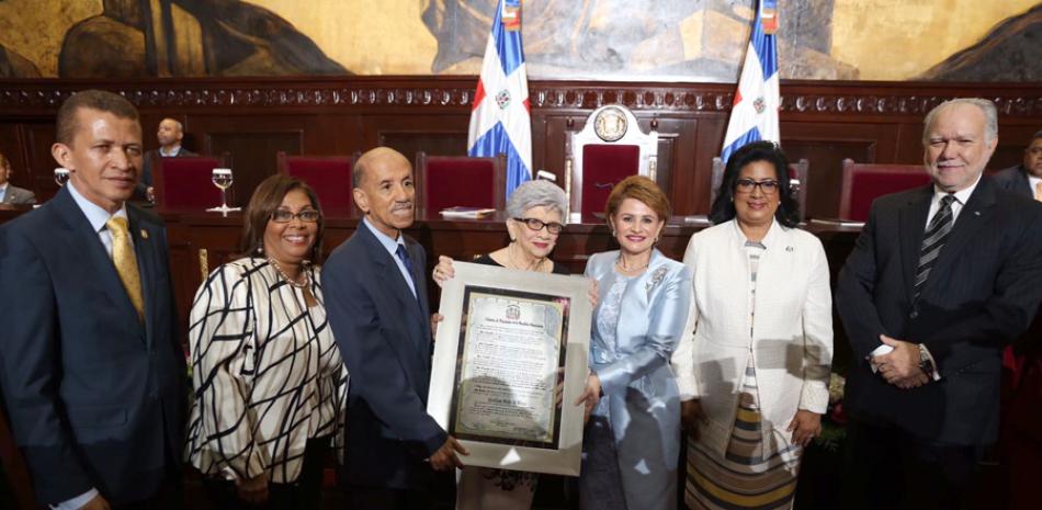 Entrega. La presidenta de la Cámara de Diputados, Lucía Medina, entrega el reconocimiento a Ivelisse Prats de Pérez.