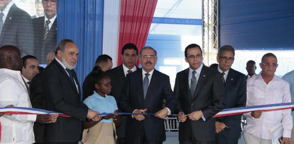 Ceremonia. El presidente Danilo Medina es visto aquí realizando el corte de cinta, en una de sus tres inauguraciones simultáneas de liceos
en la comunidad Bayaguana, de la provincia Monte Plata.