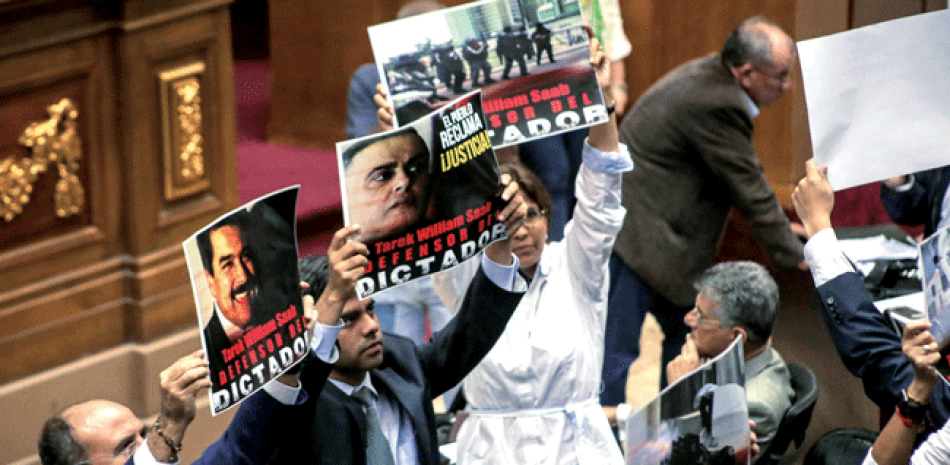 Carteles. Diputados sostienen carteles en contra del Defensor del Pueblo, Tarek Willian Saab, durante una sesión de la Asamblea Nacional de Venezuela, ayer en Caracas.