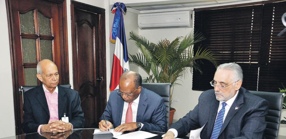 Los licenciados Héctor Mojica y Vitelio Mejía durante la firma del acuerdo entre la OMSA y la Lidom.