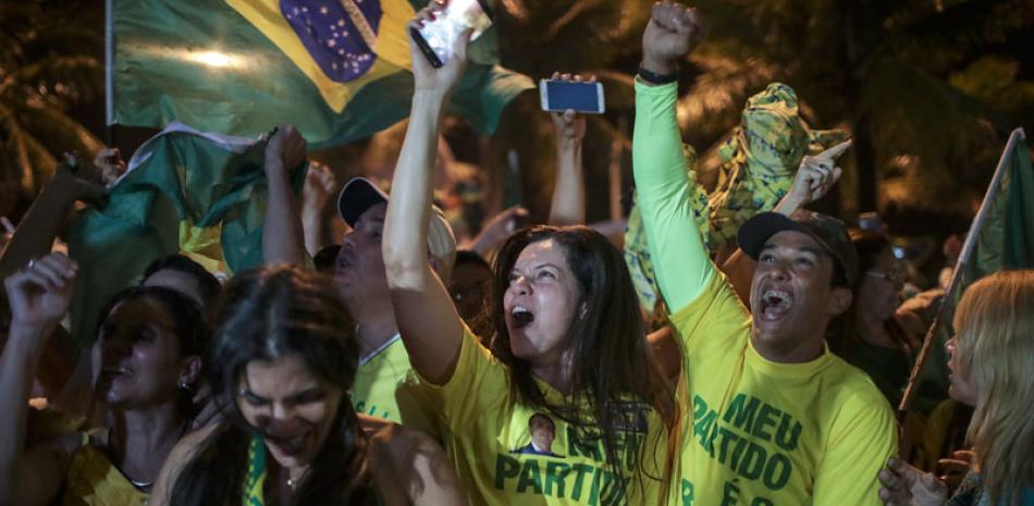 Triunfo. Partidarios de Jair Bolsonario celebran su victoria, luego de ser contablizados el 99% de los votos, cuando tenía más de 55%, mientras que Fernando Haddad, del PT, tenía menos de 45%.