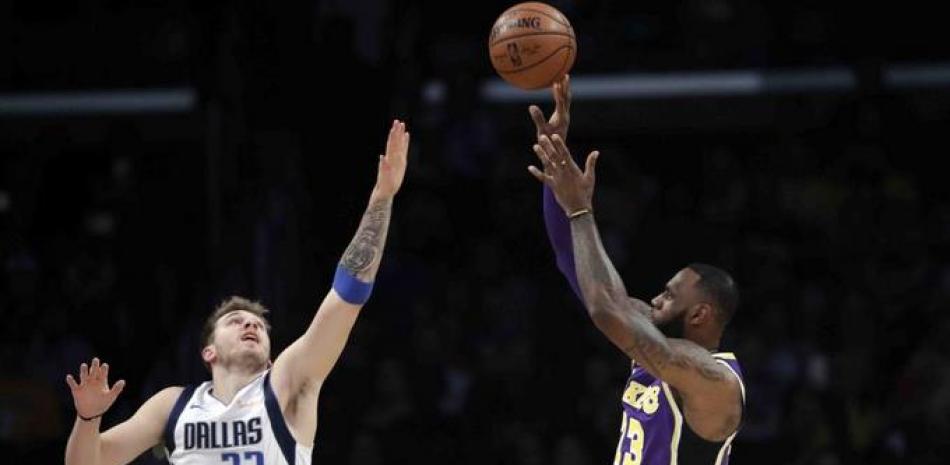 LeBron James, estrella de los Lakers, tira al canasto ante la marca Luka Doncic