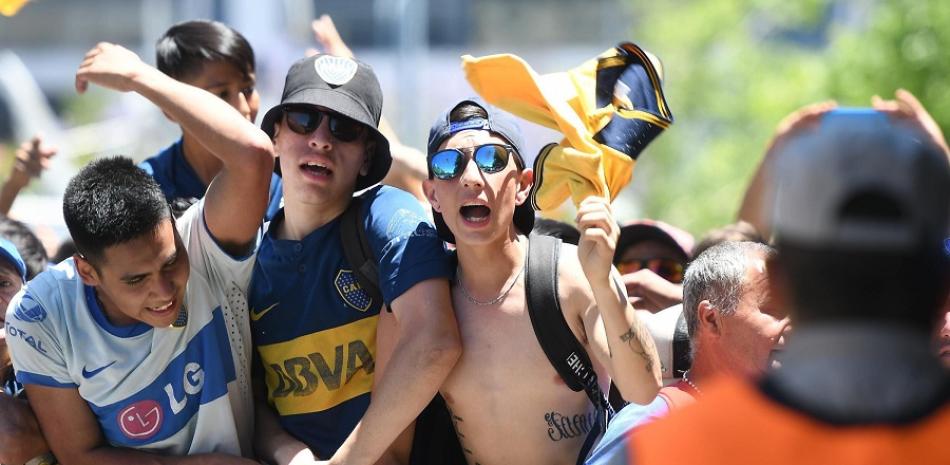 Integrantes de la prefectura argentina vigilan frente aficionados de Boca Juniors el domingo en Buenos Aires, un día después de los desórdenes que impidieron la celebración del partido.
