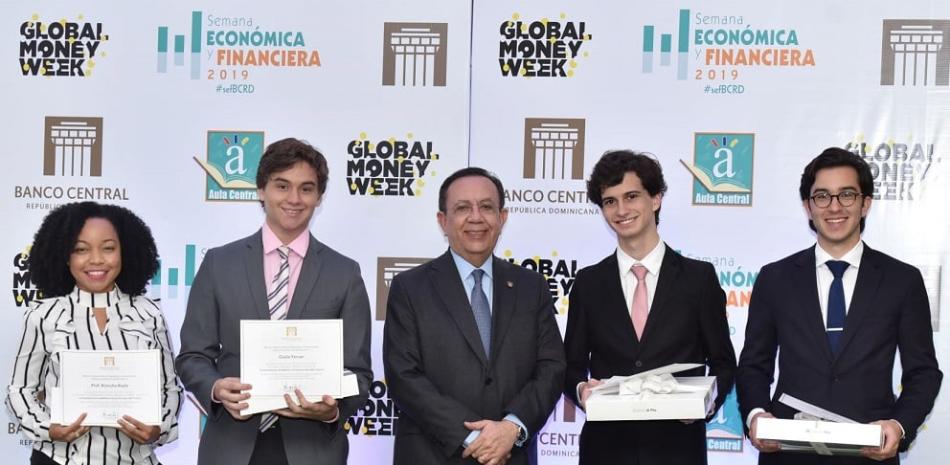 Jóvenes reciben su premio de la mano del gobernador del Banco Central, Héctor Valdez Albizu.