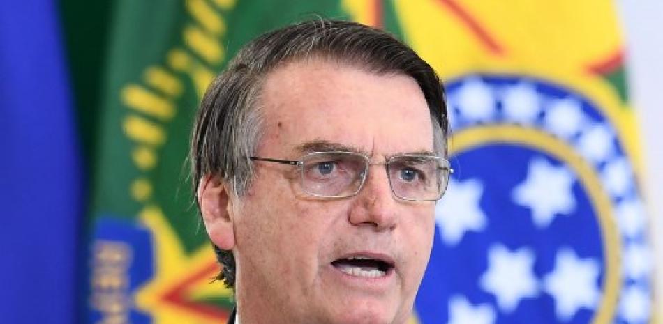El presidente de Brasil, Jair Bolsonaro, habla durante una ceremonia que marca los primeros 100 días de su gobierno en el Palacio de Planalto en Brasilia, el 11 de abril de 2019. EVARISTO SA / AFP
