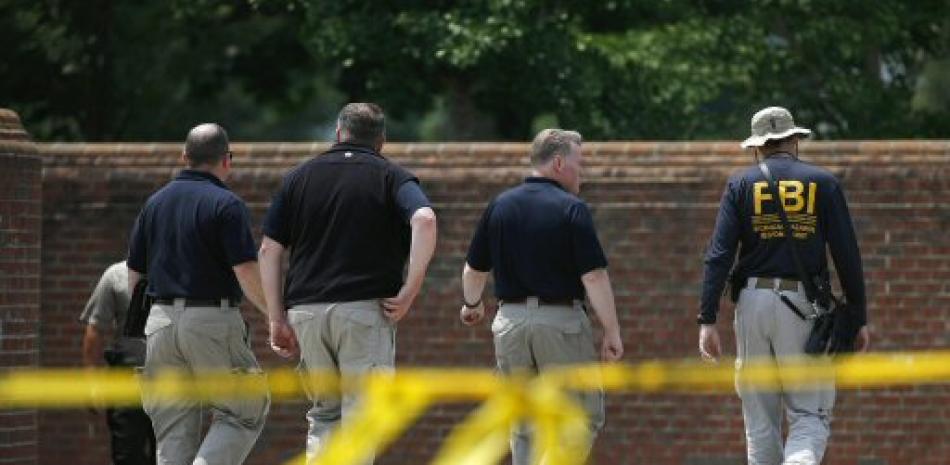 Autoridades estadounidenses se dirigen al edificio donde ocurrio la masacre. Foto AP.