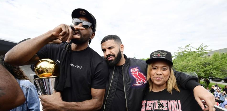 Kawhi Leonard, estelar jugador de los Raptors, junto a Drake, famoso artista y la madre de este Kim Robertson.