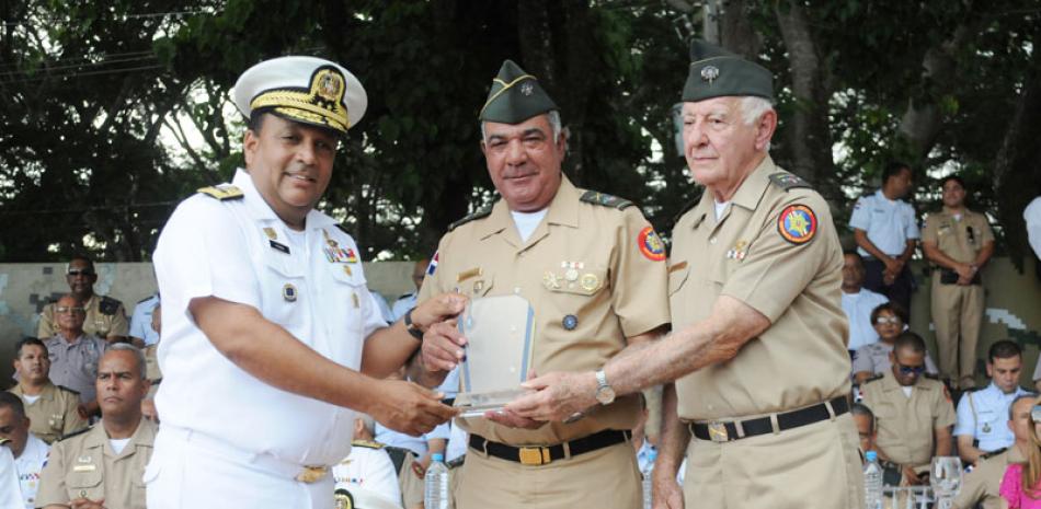 El vicealmirante Miguel Peña Acosta, en representación del ministro de Defensa, teniente general Rubén Darío Paulino Sem, y el coronel Kalil Haché entregan una placa de reconocimiento al comandante del Ejército de República Dominicana, mayor general Estanislao Gonell Regalado.