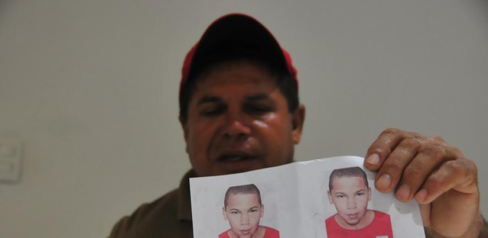El señor  Osiris Castillo Mancebo muestra la imagen de su hijo desaparecido.