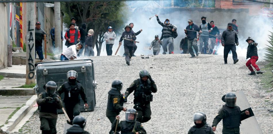 Simpatizantes del expresidente Evo Morales confrontan a la policía en La Paz, Bolivia. AP